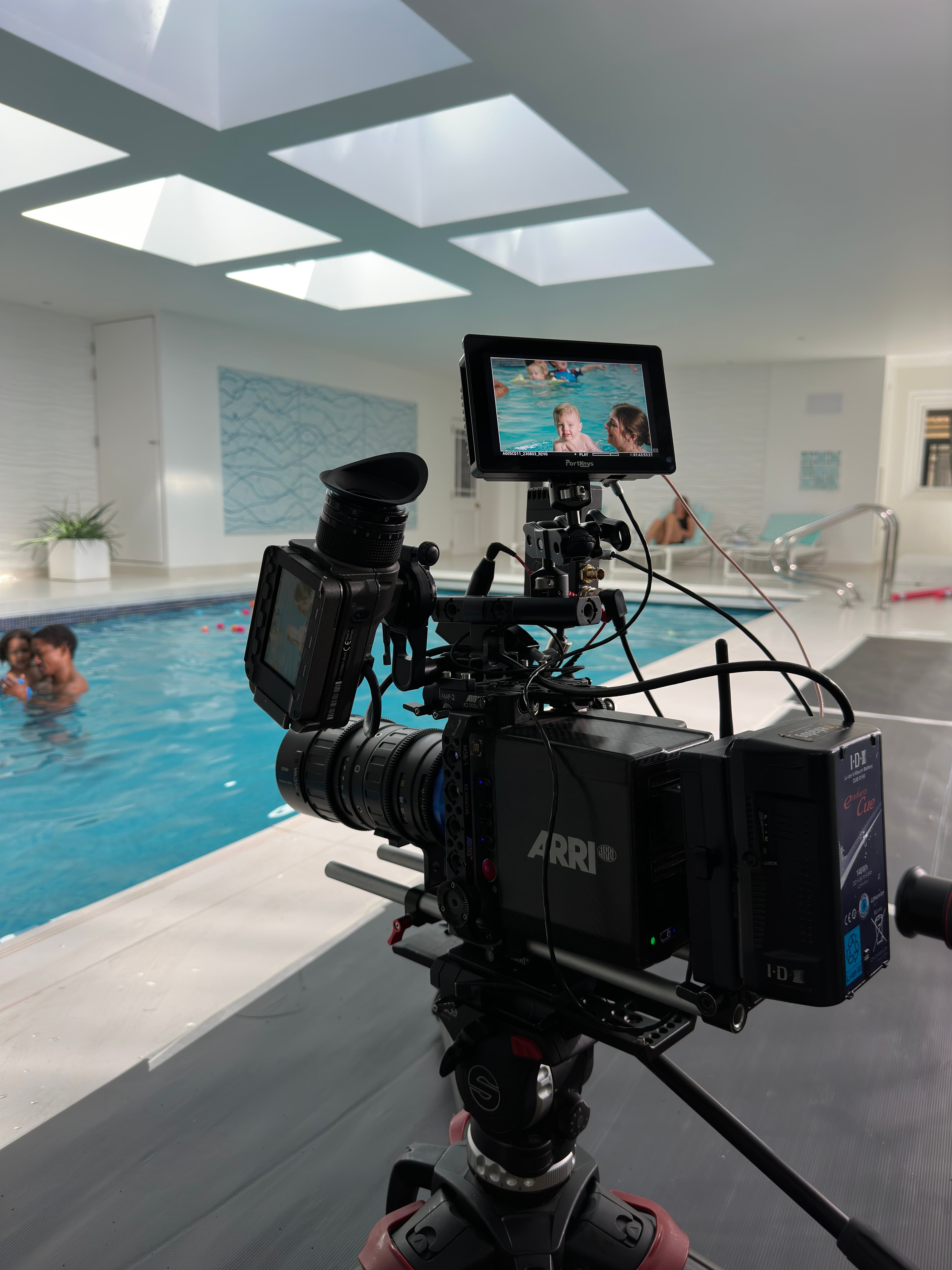 An ARRI cinema camera rig on a poolside location shoot
