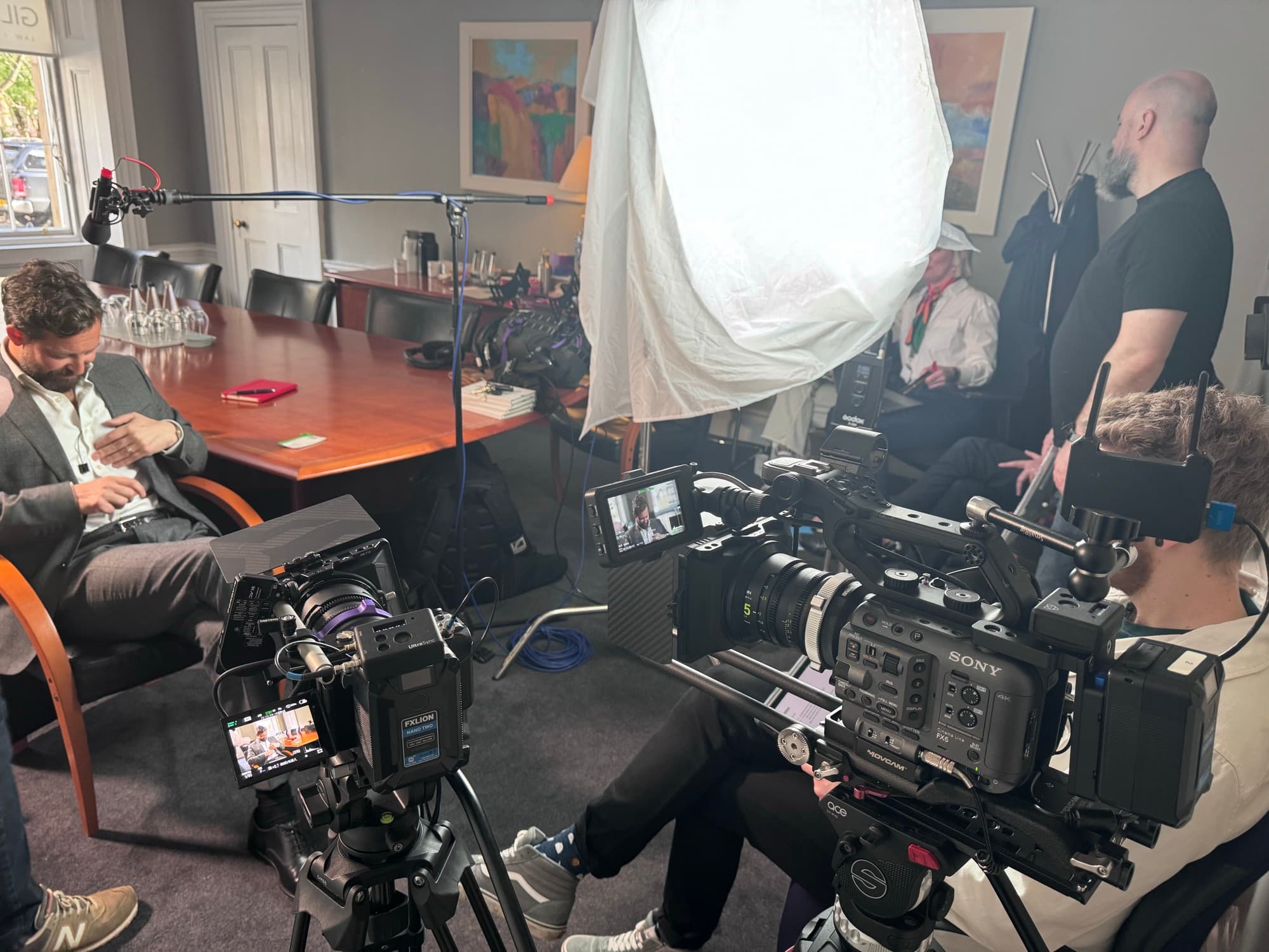 Camera and lighting arranged for an interview in a boardroom