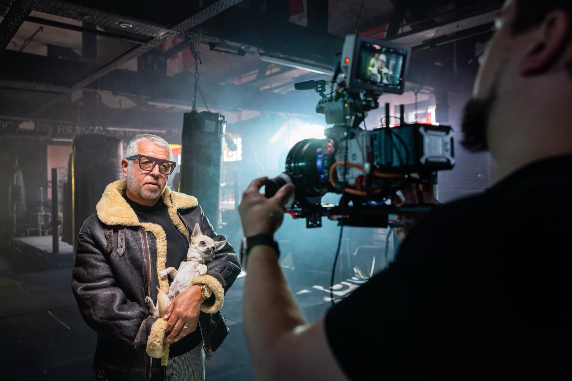 A cinema camera filming a performer on a dressed set