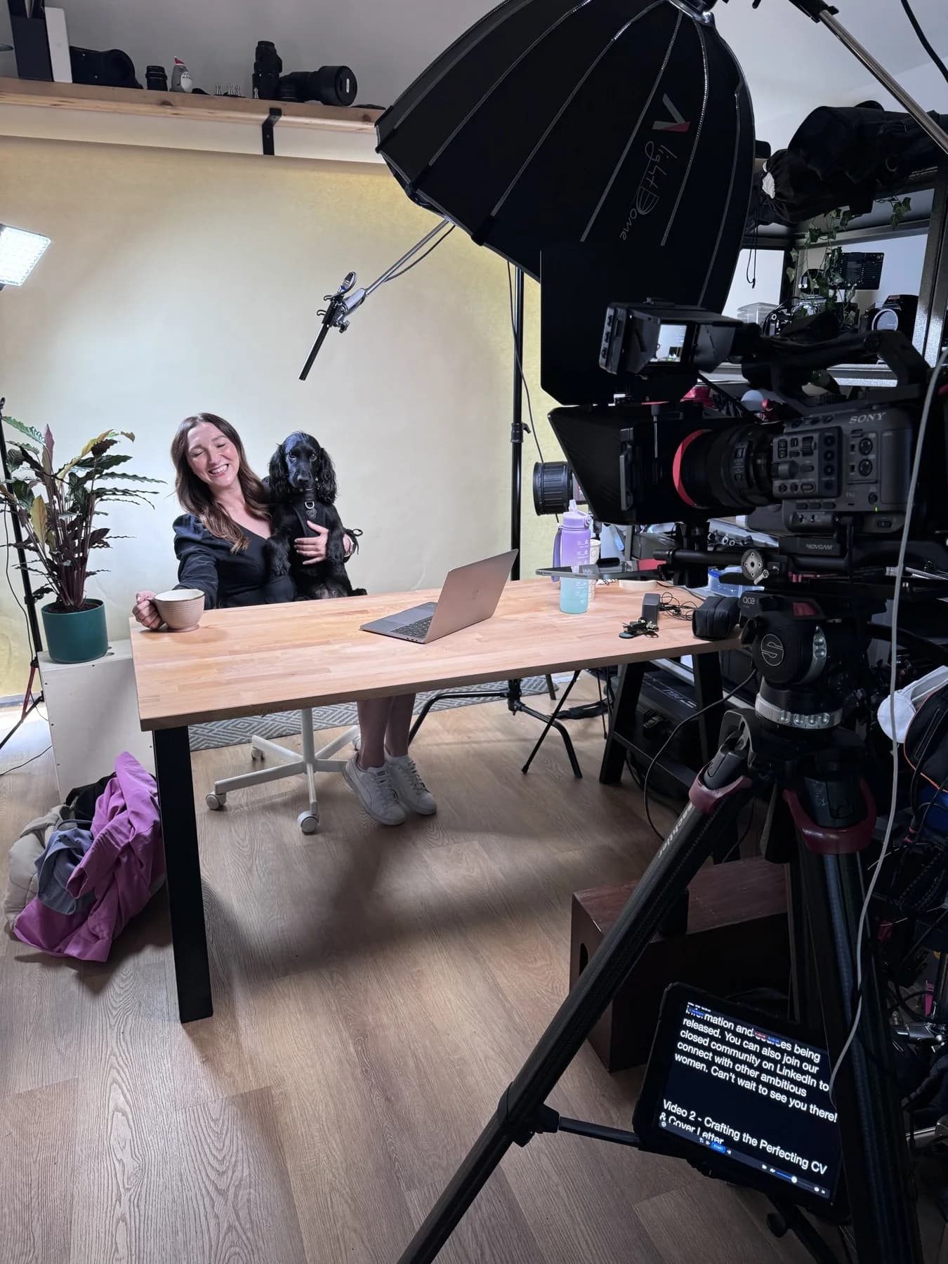 An interview subject framed by a camera and soft lighting in an office