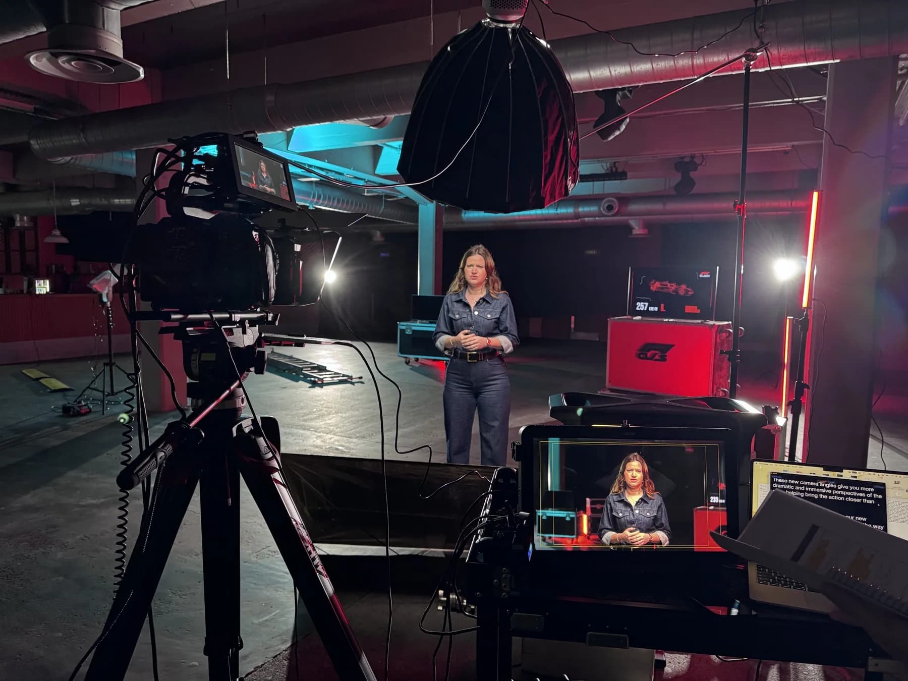 Camera monitors and controlled lighting around a seated interview subject