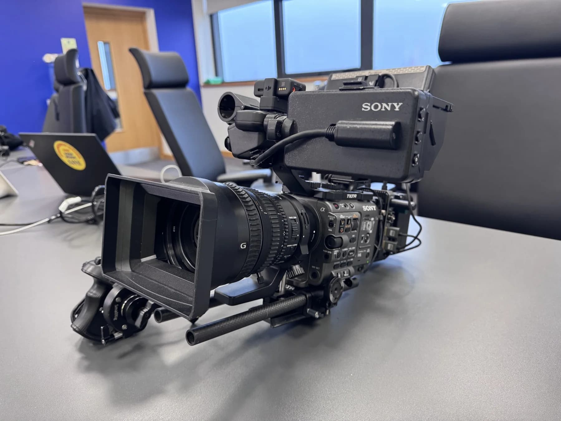 Sony video camera with a large lens and viewfinder on a table
