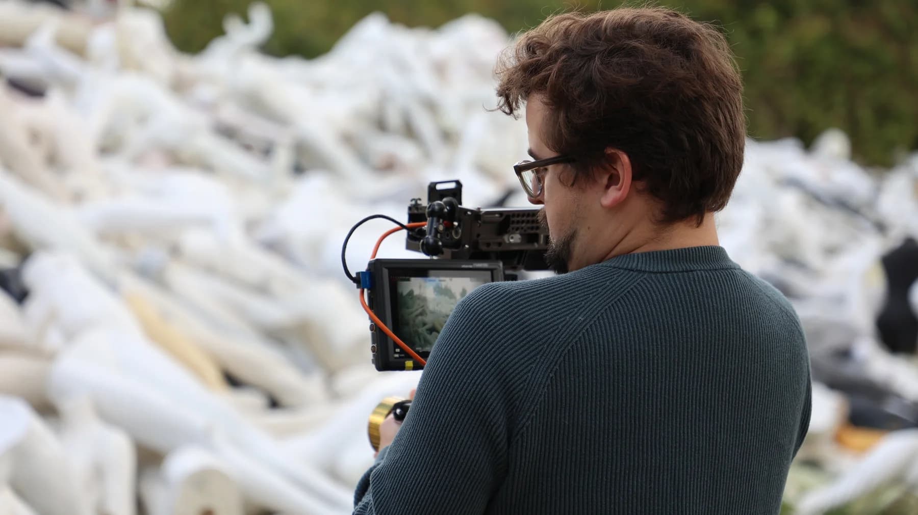 Tom Hunter checking a camera monitor on an outdoor location