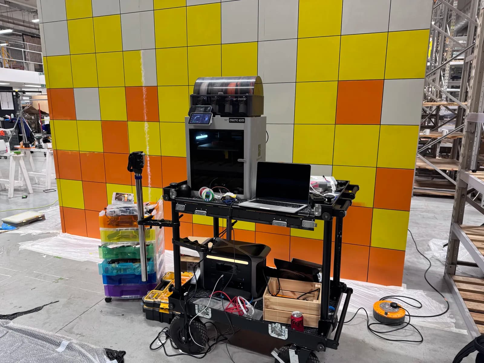 Yellow and orange tiled lift set under construction in the workshop