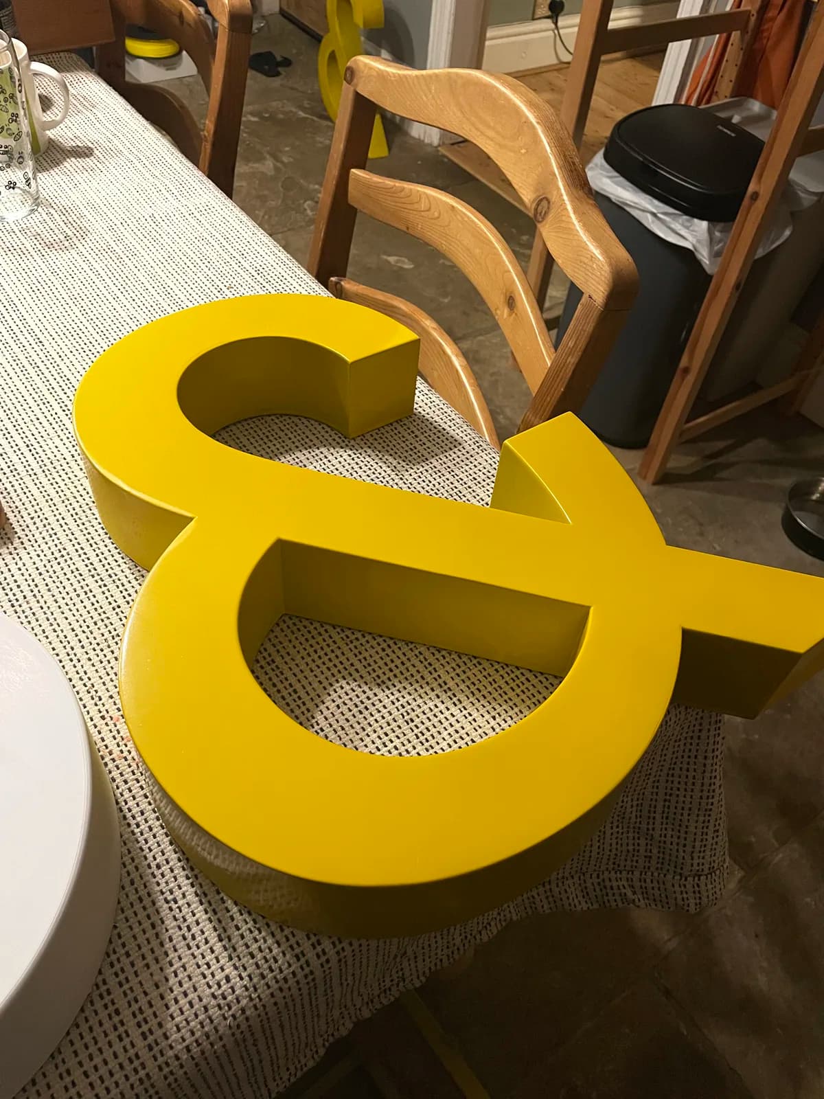 Oversized ampersands, finished in yellow enamel