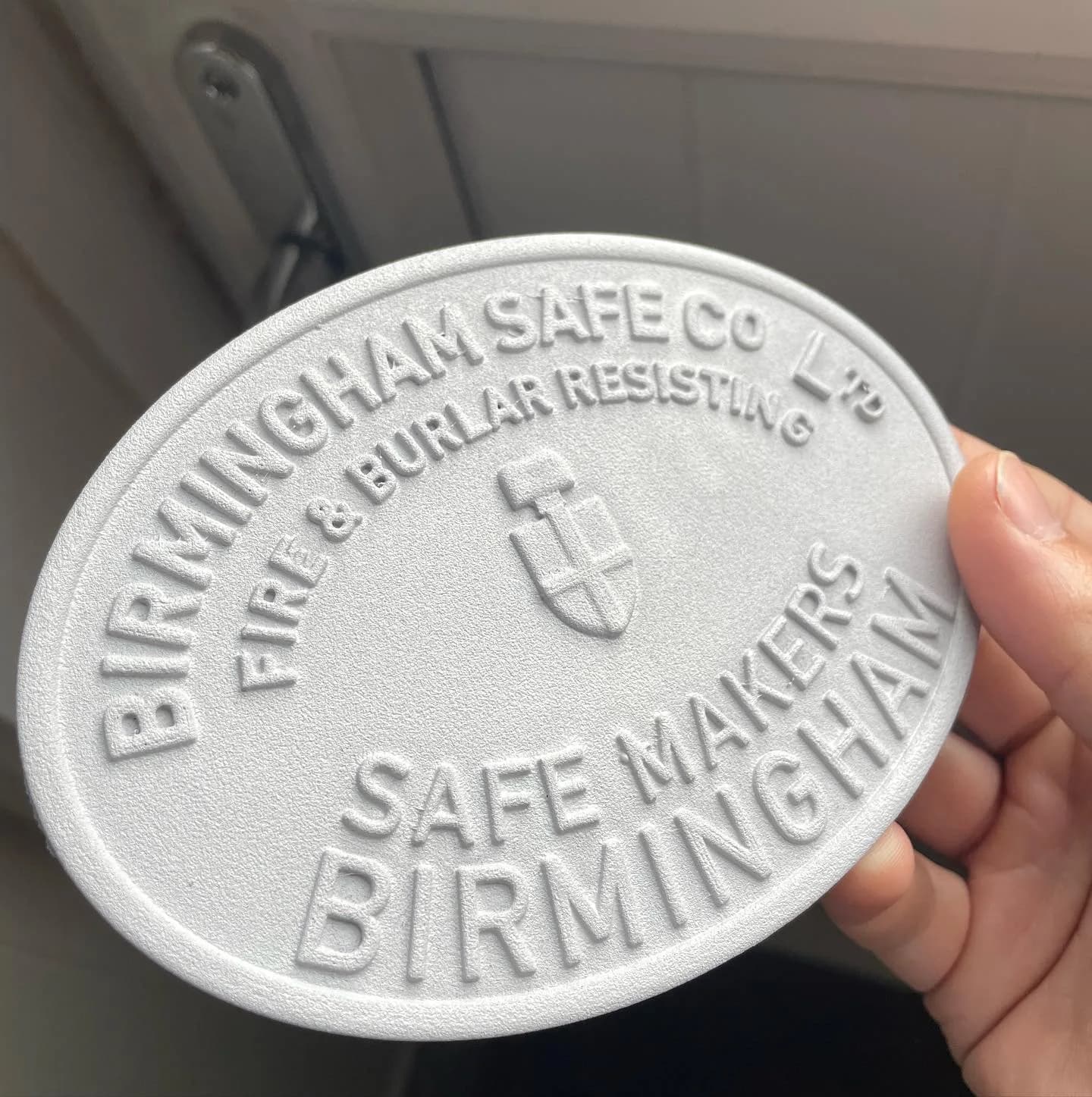 Unfinished white Birmingham Safe Co plaque with raised lettering