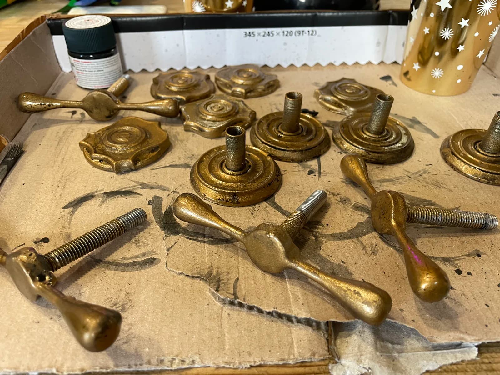 Brass-effect handles and mounting plates laid out during finishing