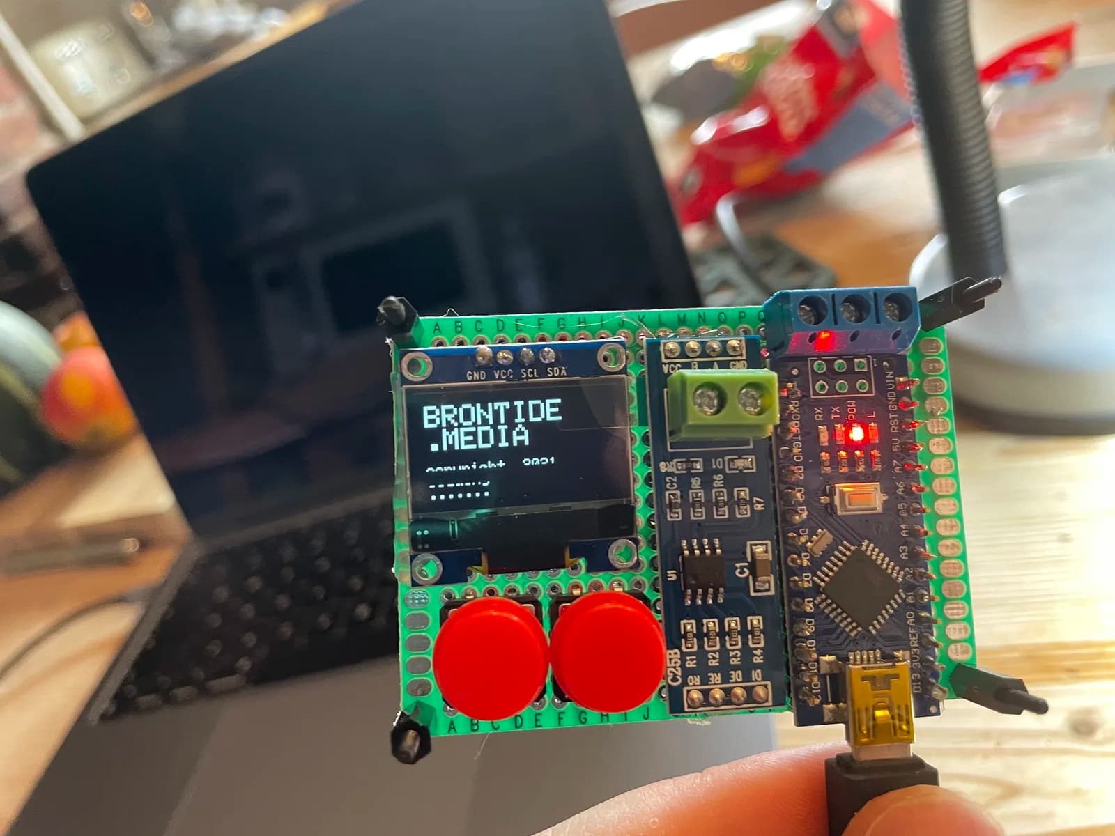 Custom controller board with a display, red connectors and illuminated status lights