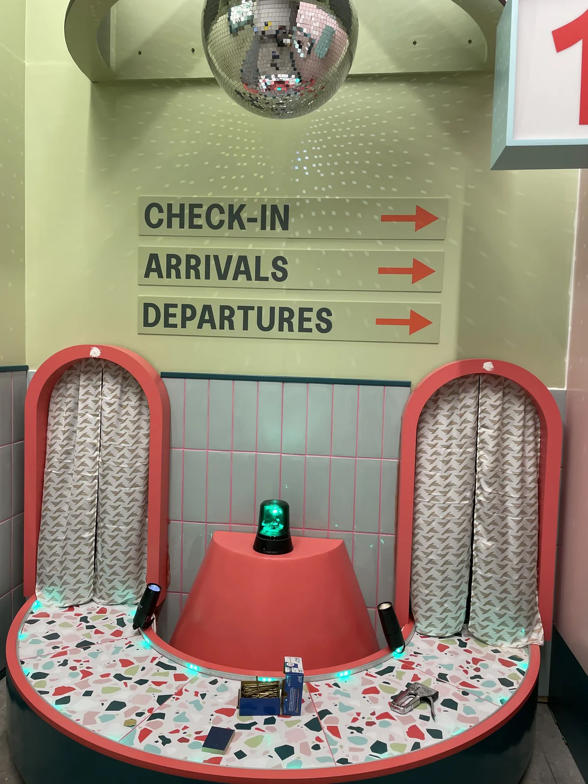 Finished check-in set with curved seats, directional signs and a central button