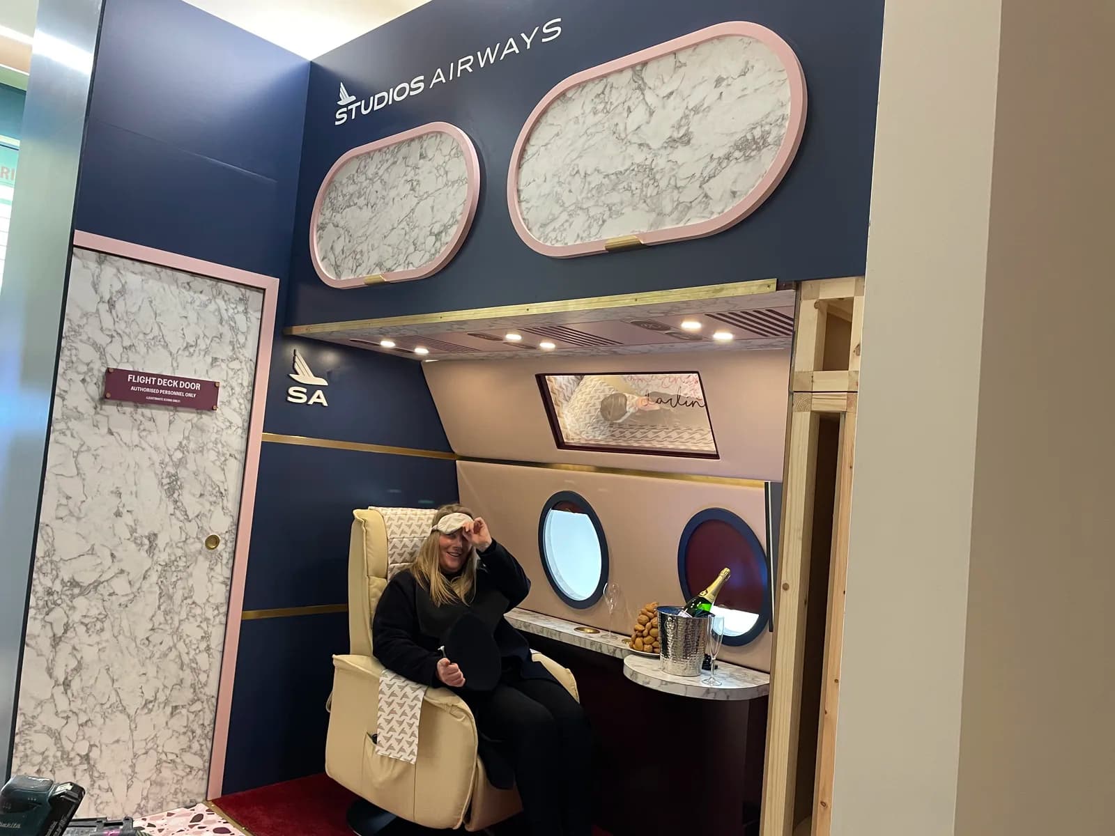 Finished airport-themed set with seating, round windows and a check-in sign