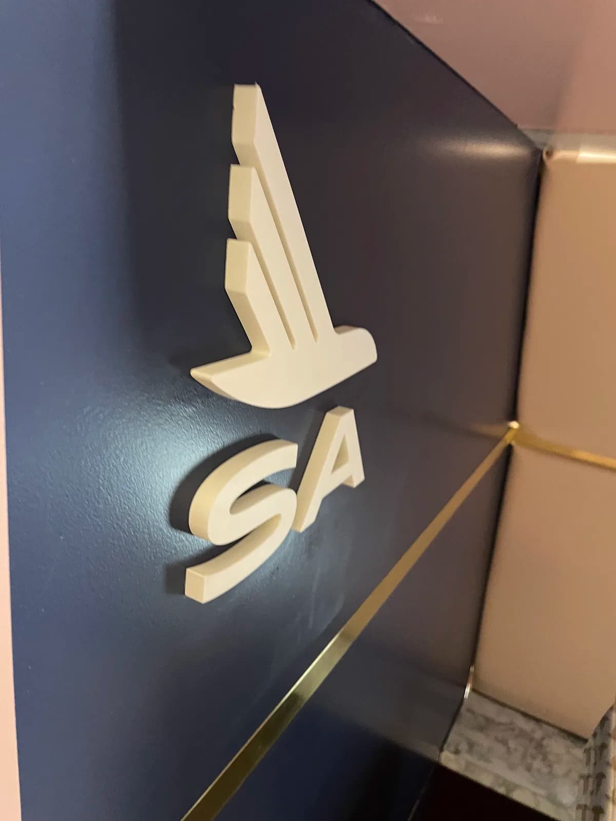 Raised SA emblem mounted on a dark finished wall