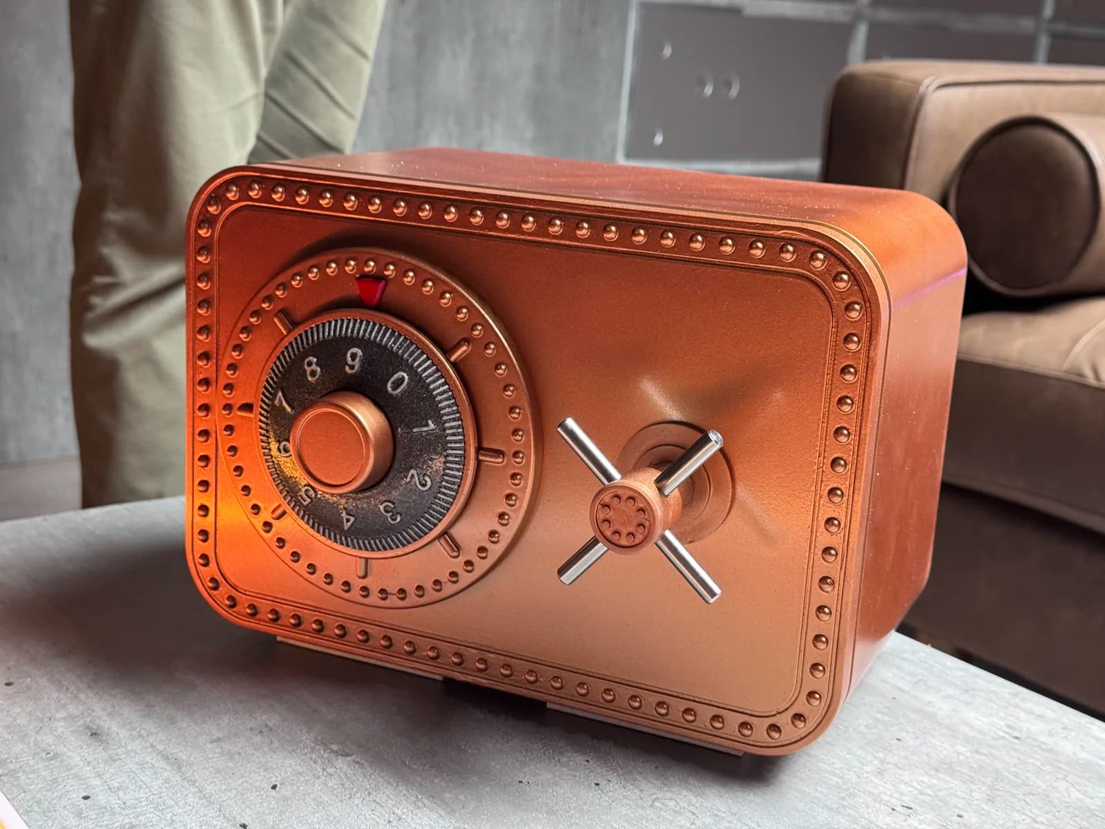 Finished copper safe prop standing beside the campaign set sofa