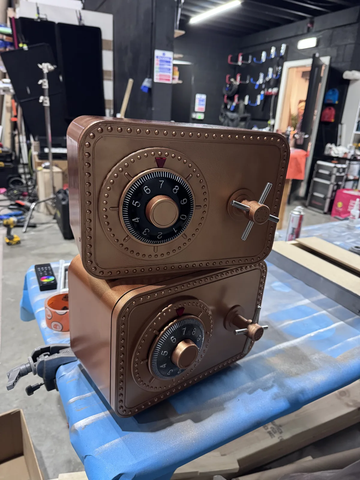 Two matching copper safe props stacked in the workshop