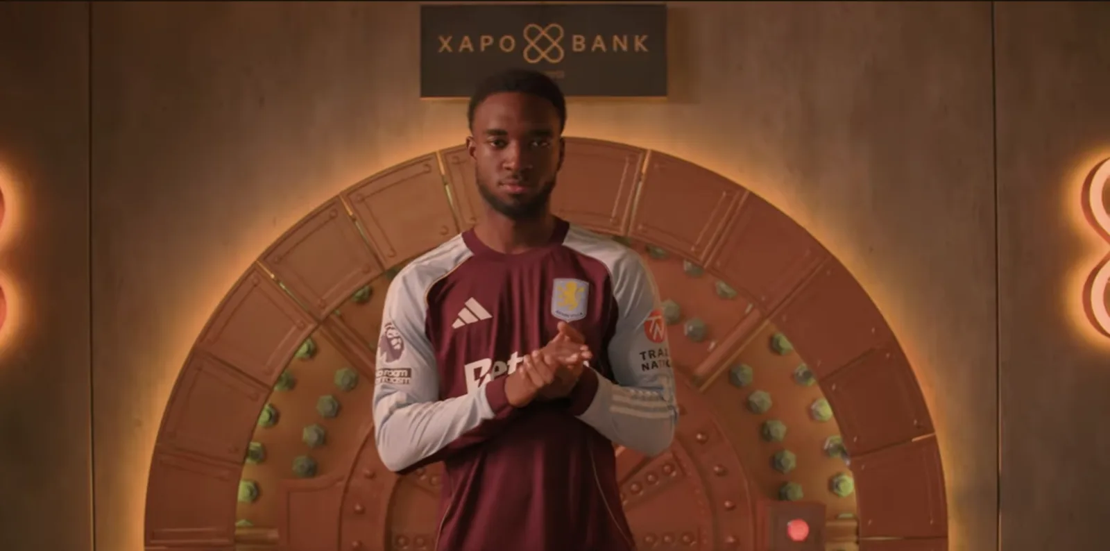 Footballer standing in front of the vault door on the finished set